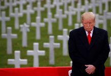 In Paris, Trump walks alone as French president rips nationalism