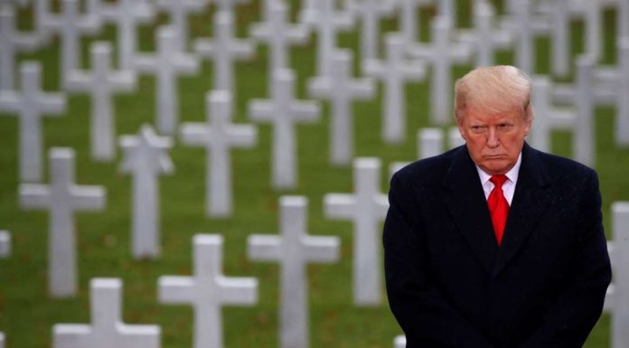 In Paris, Trump walks alone as French president rips nationalism
